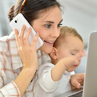 Busy mom taking phone call and helping child.